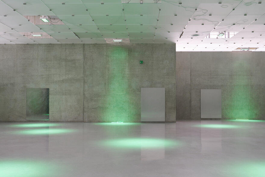 Concrete room with green lighting installation