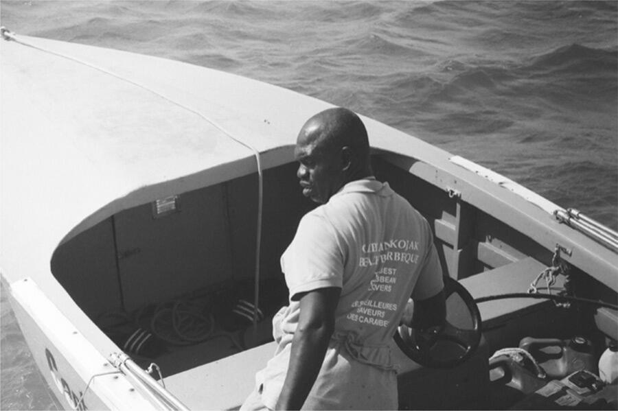black-and-white-photo-of-man-on-boat