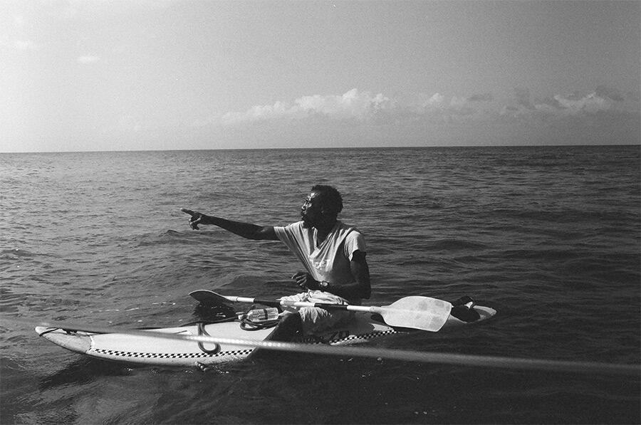 black-and-white-photo-of-man-in-small-boat-at-sea